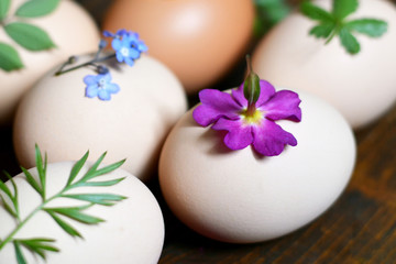  Easter eggs decorated naturally with leaves and flowers, prepared for dyeing