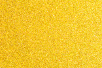Shining gold foil. Yellow metallik texture background. Golden glitter texture background