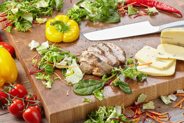 Vegetable ingredients and sliced bread on a cutting board.