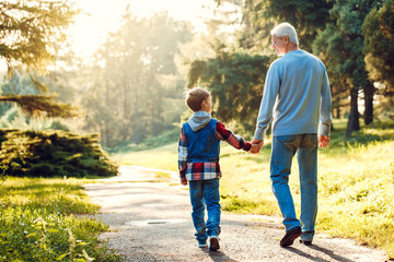 Grandfather and grandson together outdoors family concept
