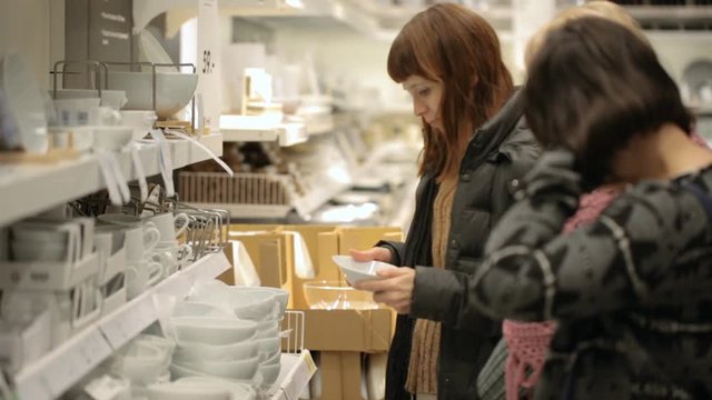 Women are choosing crockery at shop