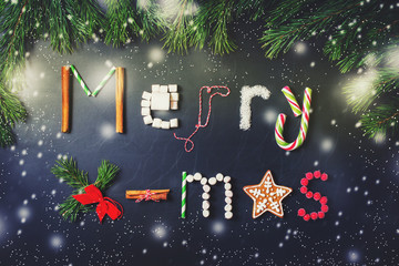 Naklejka premium Christmas card with letter from marshmallows, gingerbread, cinnamon and other thing