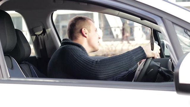 Angry driver in a traffic jam. He screams and gesticulates