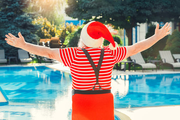 Santa Claus near the pool holiday vacation concept