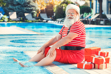 Santa Claus near the pool holiday vacation concept