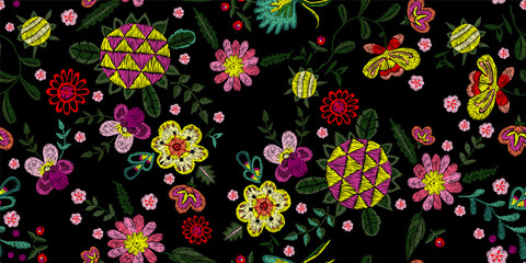 Embroidery native seamless pattern with wild fantasy flowers. Vector embroidered floral design for fashion wearing.