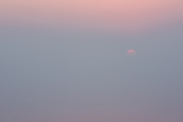 Last stage of sunset in the Great Salt Lake in Utah with the sun dissapearing into white water