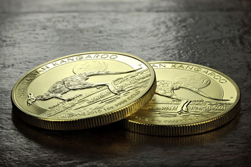 1 ounce Australian Kangaroo gold bullion coins on wooden background