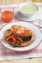 Roasted salmon with vegetables on a flat bread