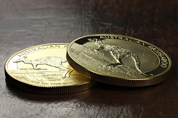 1 ounce Australian Kangaroo gold bullion coins on wooden background