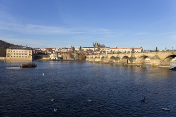 View on the winter Prague gothic Castle with the Charles Bridge in the sunny Day, Czech Republic