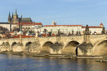 Fototapeta na wymiar View on the winter Prague gothic Castle with the Charles Bridge in the sunny Day, Czech Republic