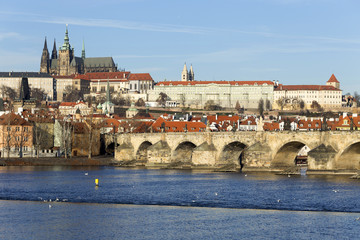 View on the winter Prague gothic Castle with the Charles Bridge in the sunny Day, Czech Republic