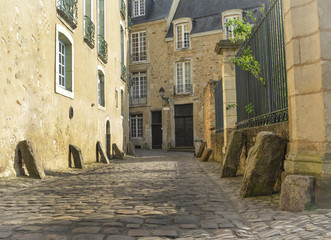 Narrow streets from paving stones with medieval stones for coachmen