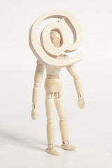 Wooden artist mannequin and wooden email sign instead of head.