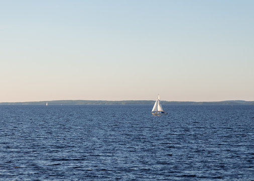 Sailing boat on a calm lake at summer