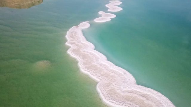 Aerial footage of the Dead Sea hotels and beaches area, flying above the salty water