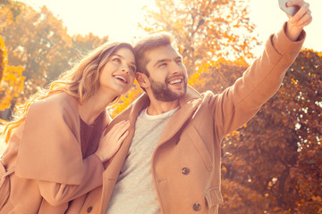 Fototapeta premium Young couple walk in the autumn park