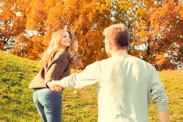 Fototapeta premium Young couple walk in the autumn park