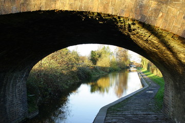 Bridge in Autumn with reflective river underneath