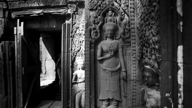 Fast boom up to reveal female divinity carvings in high relief from the Hindu epics and Buddhist mythology on Thommanon.