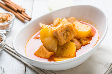 Massaman pork curry on wood background. Coconut milk curry.