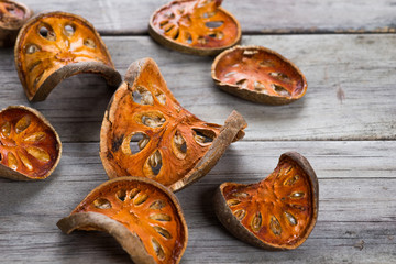 Dry Bael fruit - Slices of dry Bael fruit on the wooden table