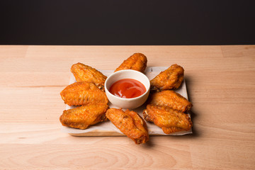 plate of chicken wings on wood