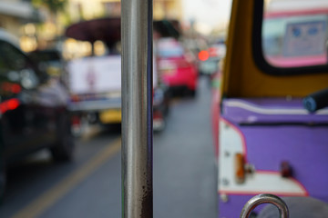 holding rod dirty in thai tuk tuk