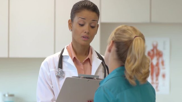 Female doctor talking with patient
