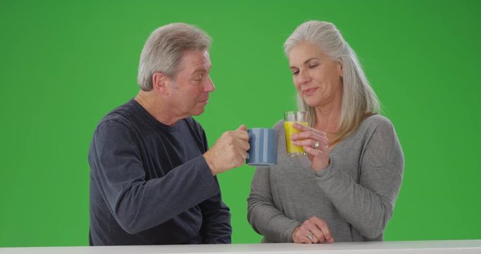 Mature senior couple enjoying breakfast drinks together