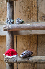 cones and a Santa Claus hat lying on old wooden stairs