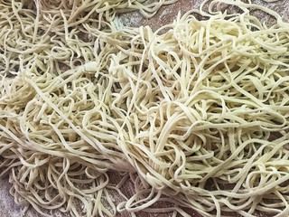 Closeup of floured angle hair pasta on a cutting board