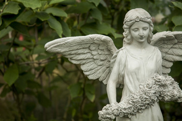 Landscaping with tropical plants / Decorated with statues of angels