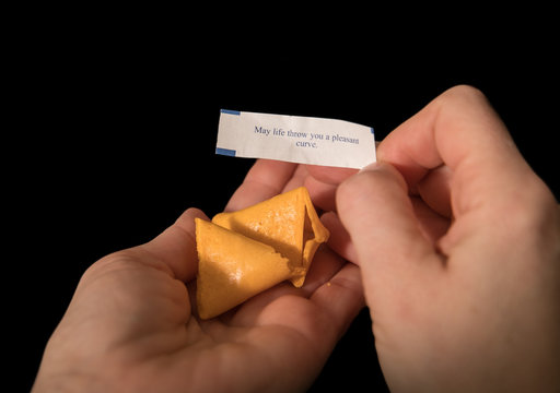 fortune cookie says "may life throw you a pleasant curve." Stock Photo |  Adobe Stock