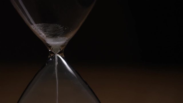 Sand timer finishes as sand falls through the funnel