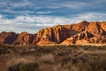 Spectacular sunrise illumination of the Navajo Sandstone mountains of Snow Canyon State Park in Utah.