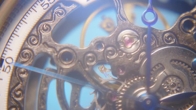 The work of mechanism of a wristwatch antique style in ray of light. Macro. Closeup. Shallow depth of field. Slow mo, slo mo, slow motion, high speed camera, 240fps, 250fps