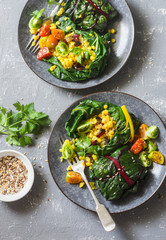 Swiss chard packets. Chard leaves stuffed with turmeric lentils and vegetables. Vegetarian healthy food concept. On a grey background, top view