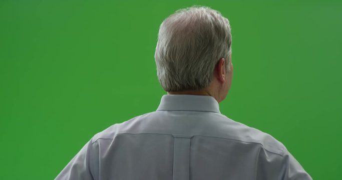 Senior caucasian male facing a green screen