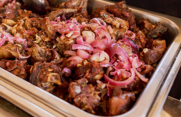 Delicious tray of meat with onion rings