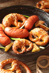 pretzels with sesame seeds and salt, fried cabbage, potatoes, shpikachki and beer