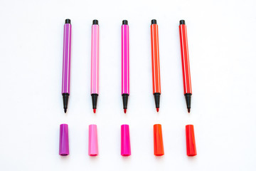 Colorful magic pens with cap isolated on white background. (Selective focus)