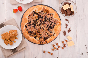 Sweet chocolate pizza with cookies.