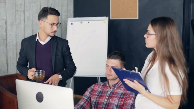Team brainstorming process. Coworkers discussing new ideas in modern office
