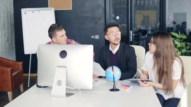 Coworkers in a modern office working on project in company