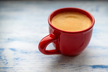 coffee in a red mug on an old wooden background 
