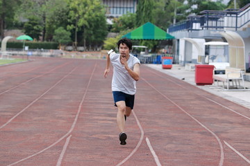 Obraz premium Runner athlete man running on the trackrace in stadium . Jogging for healthy concept