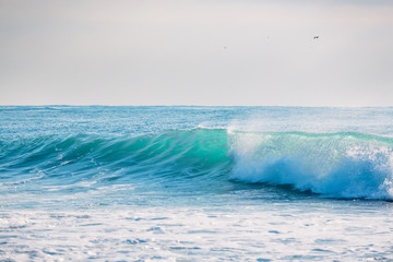 Blue wave crashing in ocean. Crystal wave in Bali