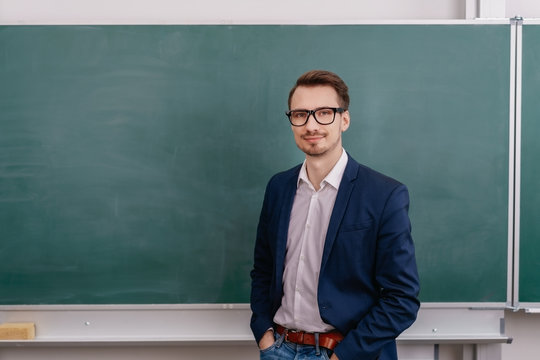 Confident male teacher wearing glasses